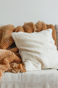 Cozy Blanket on Minimal Sofa Isolated